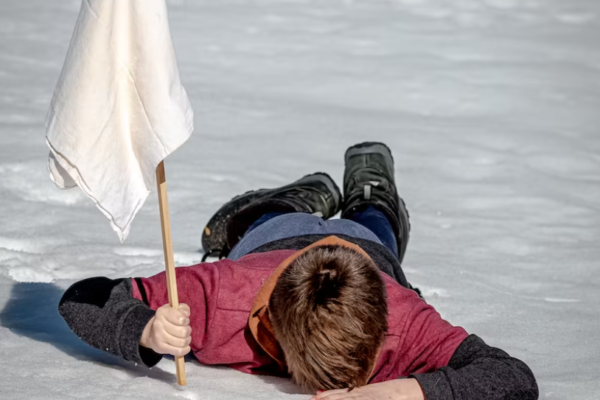 Man face down with white flag Man face down with white flag